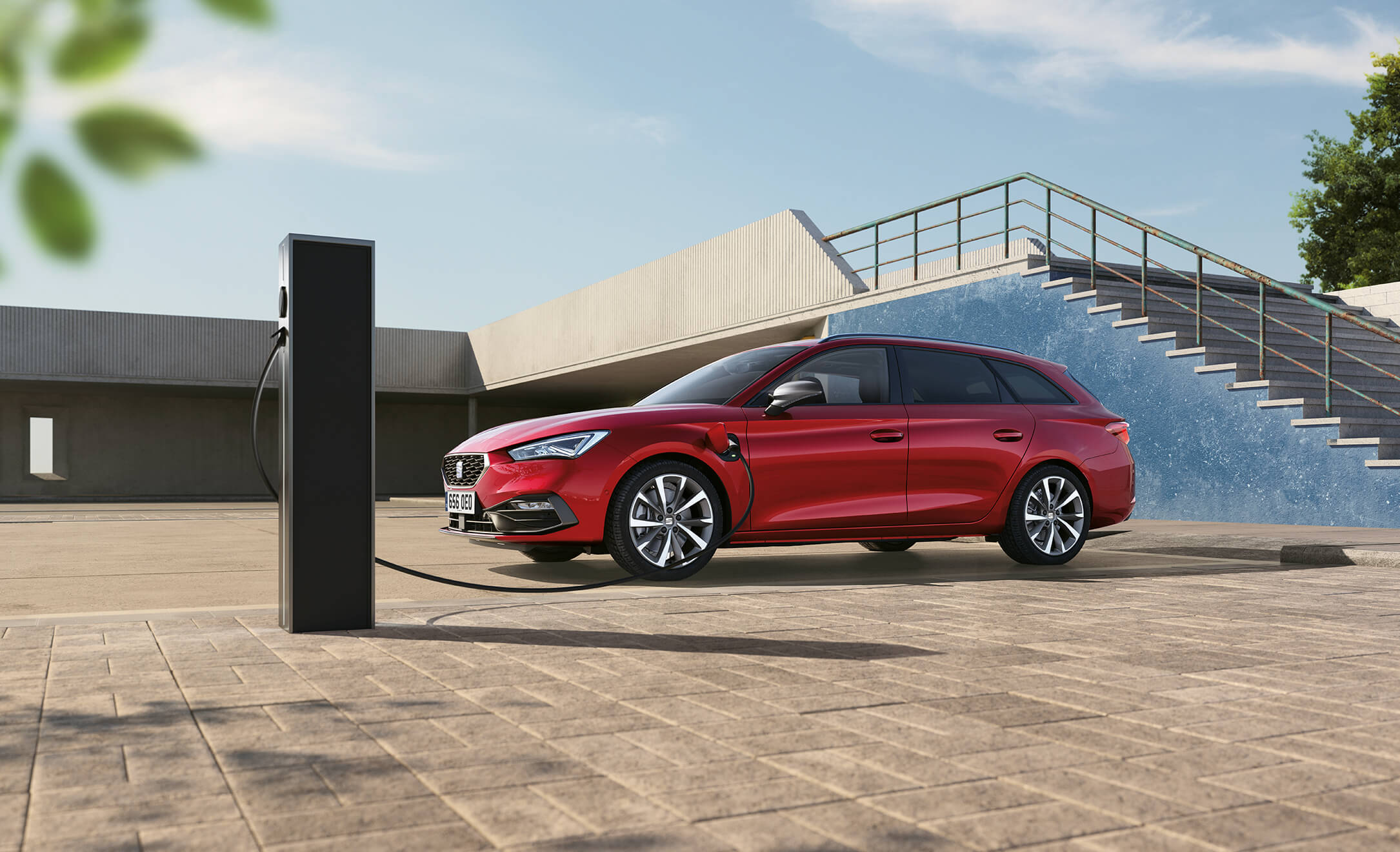 Leon Estate e-HYBRID FR Sport in red, parked and charging